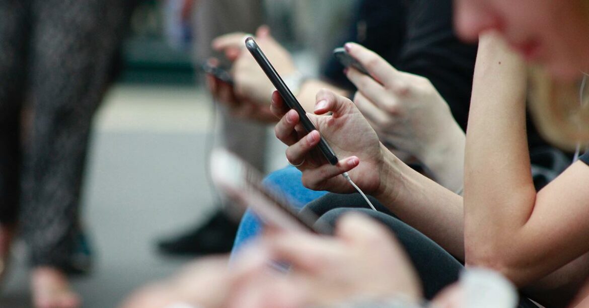people-on-train-looking-at-phones.jpg