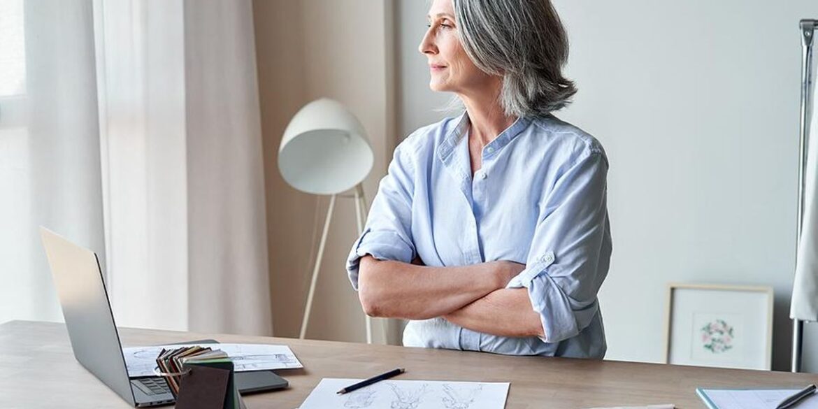 professional Woman grey hair laptop working job remote